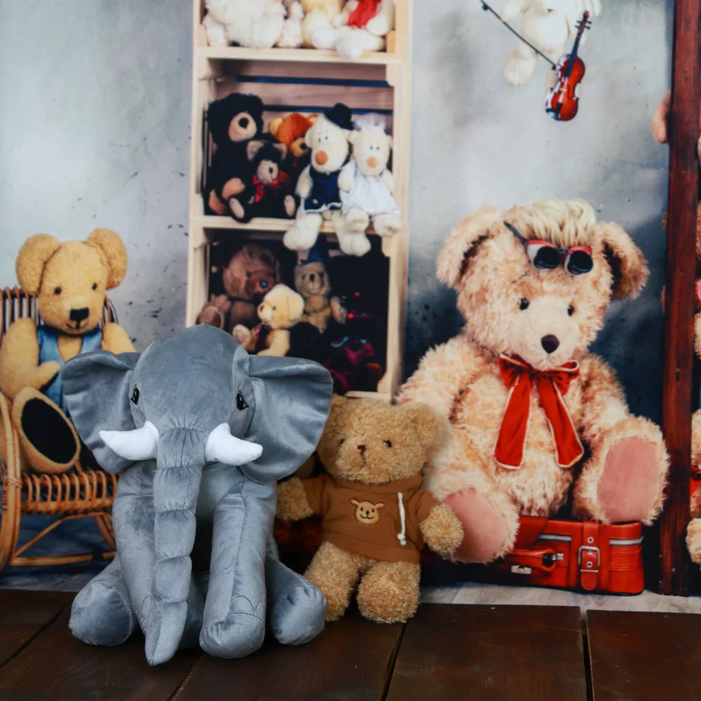 Plush teddy bears and an elephant on a shelf